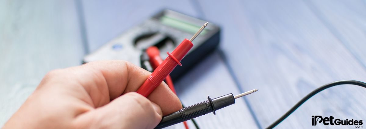a human holding Multi meter wire