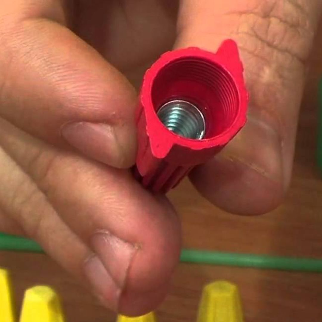 A human holding a wire cap